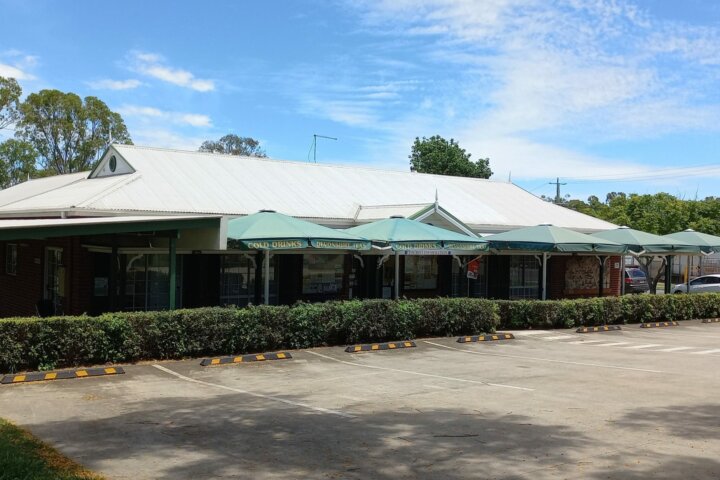 Our lovely building with the umbrellas over our Tea Garden for shade while enjoying a Devonshire Tea