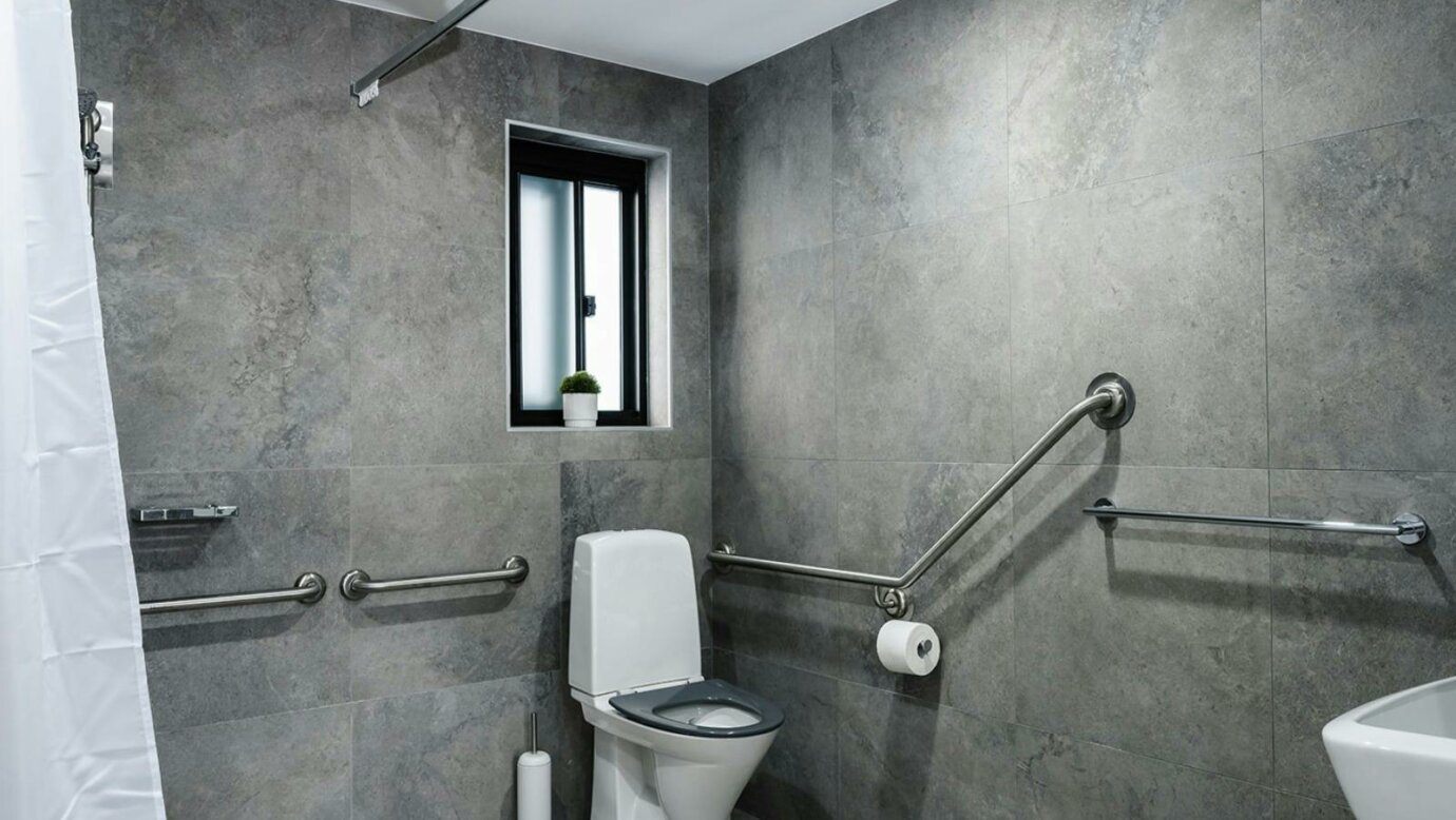 Bathroom with grab rails on the walls for full access