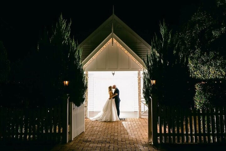 Newly weds kissing in front of the White Chapel, Kalbar, Queensland, Australia