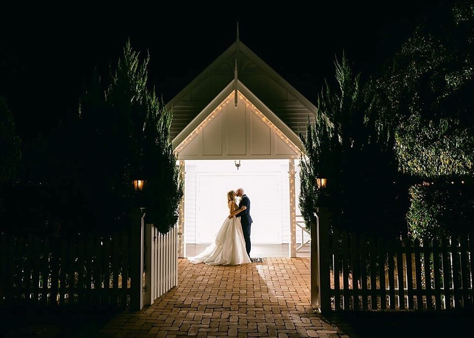 Newly weds kissing in front of the White Chapel, Kalbar, Queensland, Australia