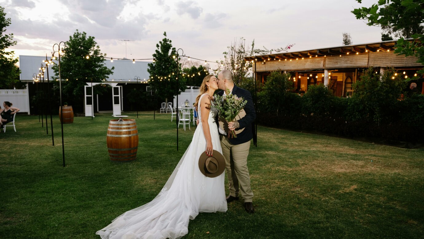 couple outside the barn bar