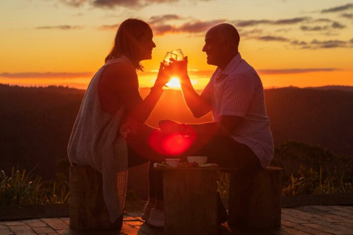 An image of two guests enjoying the sunset at Binna Burra