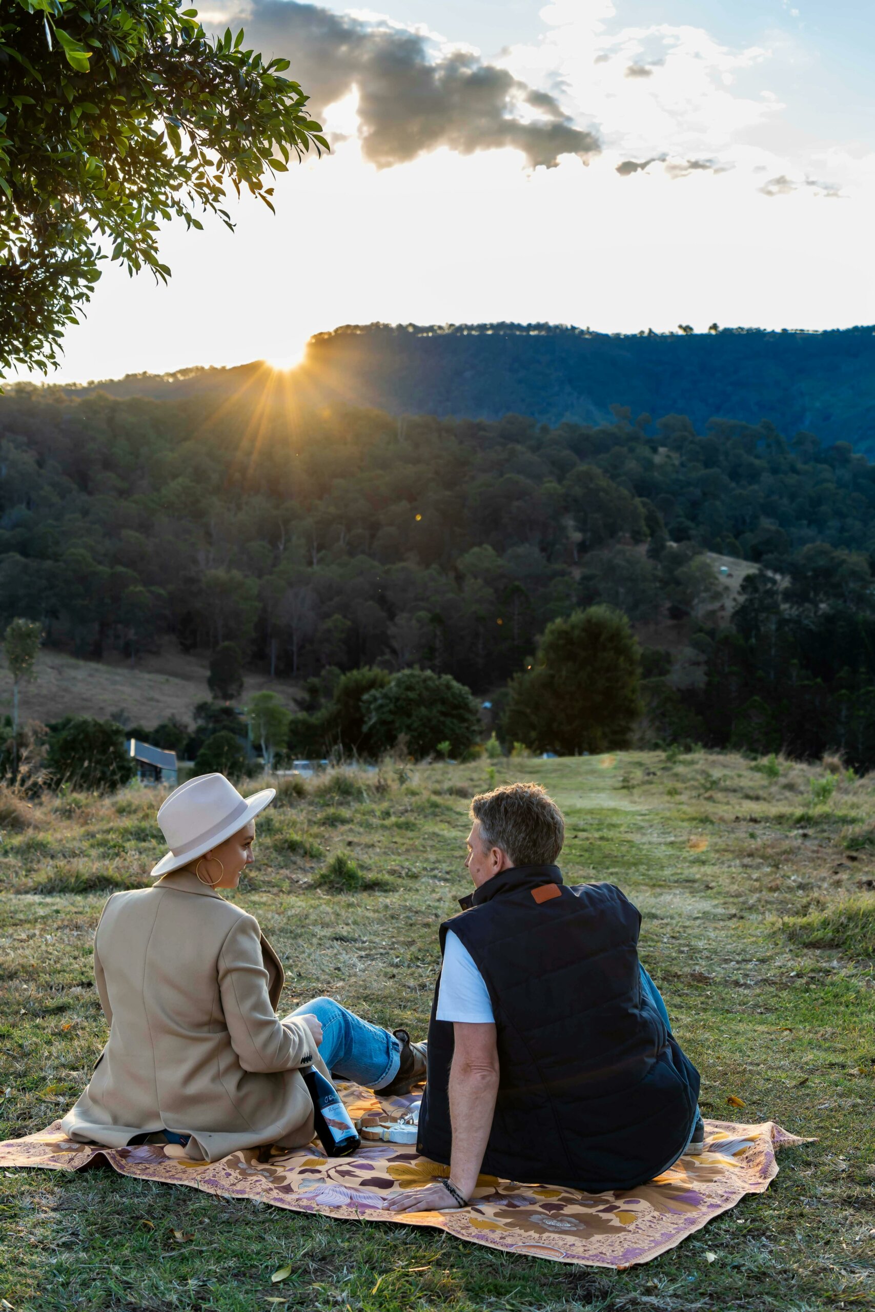 Couple having a picnic, taking the view of Country Mile Escape