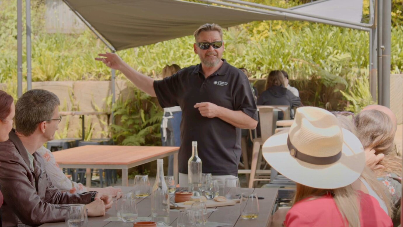 South East Discovery Tours host, PJ, presenting wine to the group